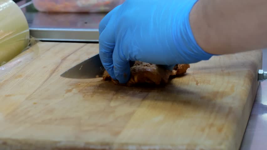 Cooking meat shawarma in pita bread. Shawarma pita vegetables cabbage onion, cooking tongs put vegetables on pita bread, close-up of the process of cooking shawarma in pita bread. | Shutterstock HD Video #1108760089