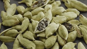Lots of cardamom spices slowly scroll clockwise, macro video footage. A great background for your projects.