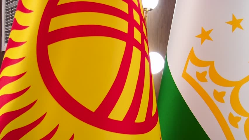 Closeup of Kyrgyzstan and Tajikistan flags