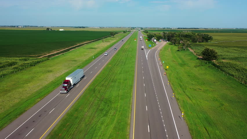 Aerial view flying over traffic on the Nebraska highway 1, sunny, summer day in USA