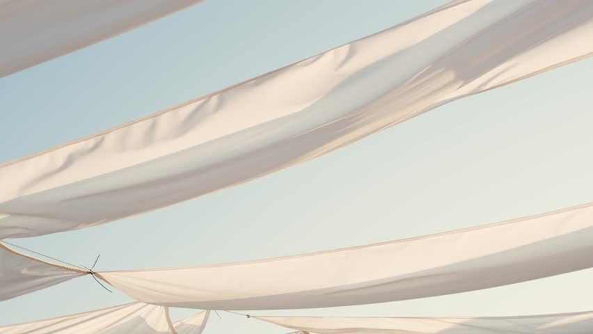 Waving white fabric on sunrise at the ocean beach on sunrise