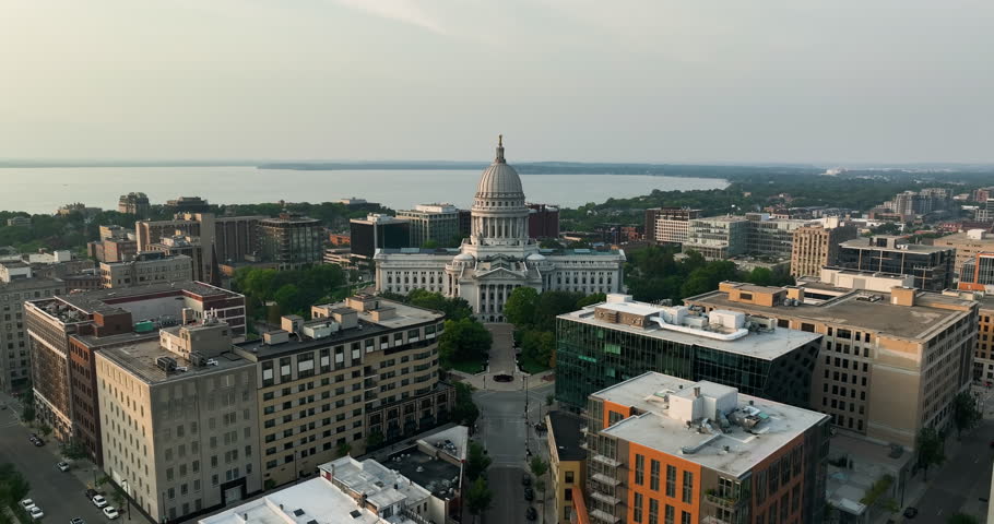 Flying backwards above Madison downtown buildings, and street leading to the Wisconsin State Capitol