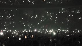 Many fun people lift hand up hold cell phone flash light. Fan crowd wave flashlights. Epic live music concert atmosphere. Big open air k pop arena. Cool night fest. Lot joy men hang out. Kpop chill. - Powered by Shutterstock - Get 15% off with code: PIKWIZARD15