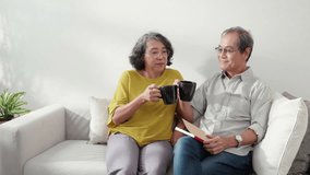 Happiness senior couple sitting on sofa cheer coffee cup and drinking in living room at home, happy elderly man and woman sitting on couch drinking coffee and talking with cozy, bonding and relation. - Powered by Shutterstock - Get 15% off with code: PIKWIZARD15