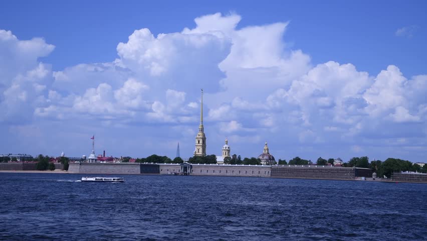 Tour boats sails on blue  Neva river next to Russian Orthodox Saints Peter and Paul Cathedral in a sunny summer day in Saint Petersburg, Russia. Real time handheld video. Travel destinations theme | Shutterstock HD Video #1108776467