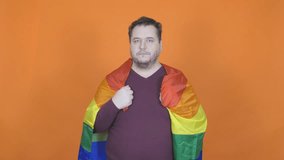 Funny fat man posing with a gay flag.