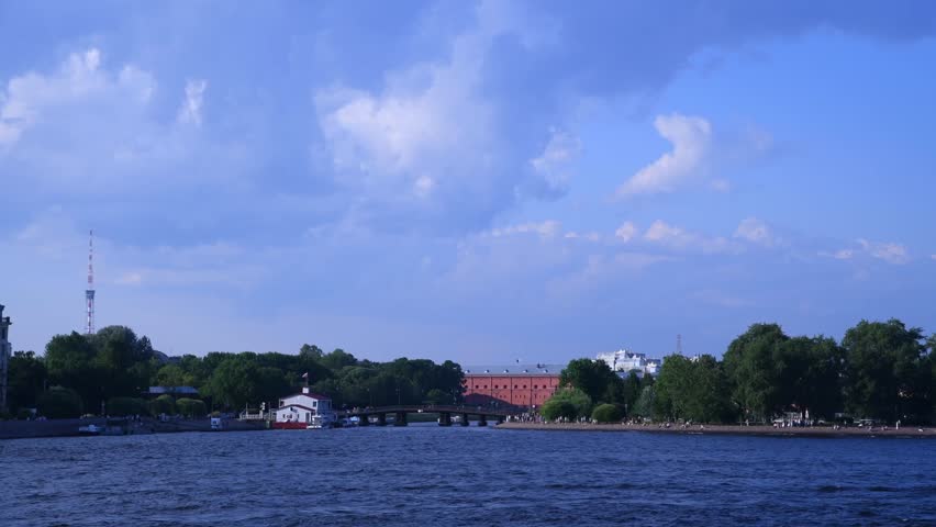 Cityscape of Saint Petersburg, Russia. Tour boats sails on blue  Neva river next to Russian Orthodox Saints Peter and Paul Cathedral in a sunny summer day. Real time panoramic handheld video. | Shutterstock HD Video #1108779249