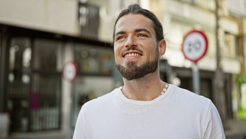 Young hispanic man smiling confident standing at street