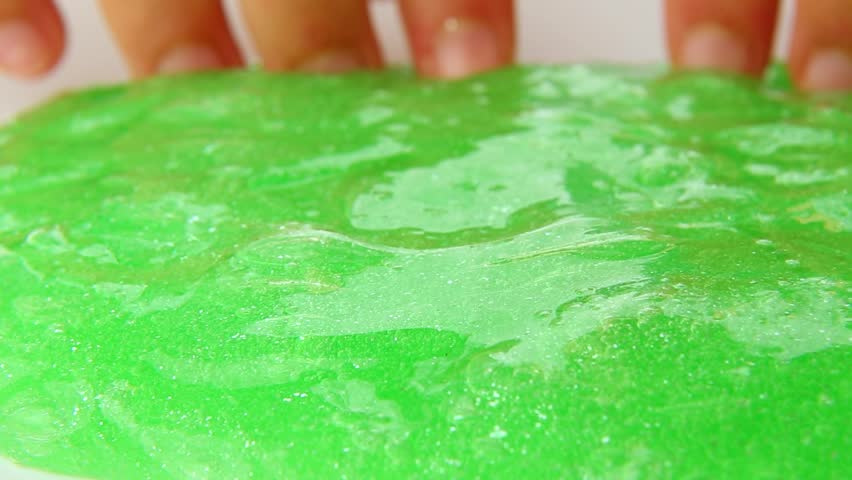 The guy is having fun with a toy of green slime with his fingers pressing on the slime. ASMR videos for relaxation. Part 1 Royalty-Free Stock Footage #1108786257