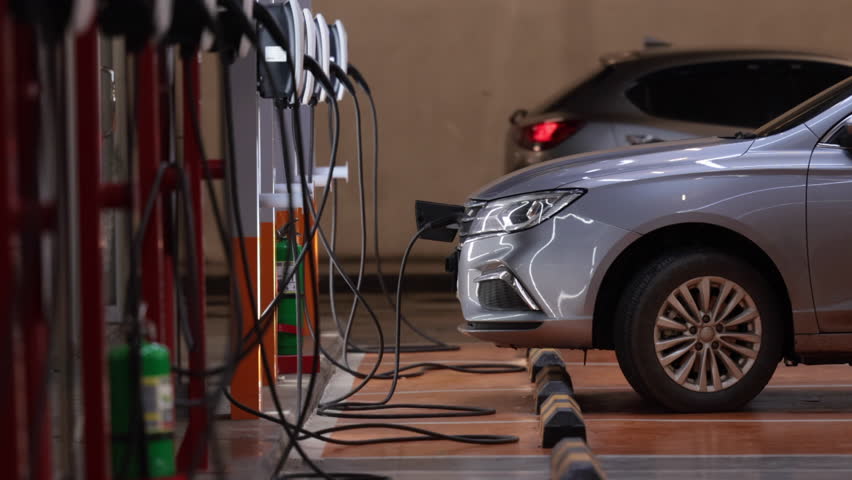 EV charging an electric car.Power supply for electric car charging. Socket for electric car battery charger. EV car charging station. Nature energy, Clean energy, Green eco concept. Plugging in cable. Royalty-Free Stock Footage #1108787069