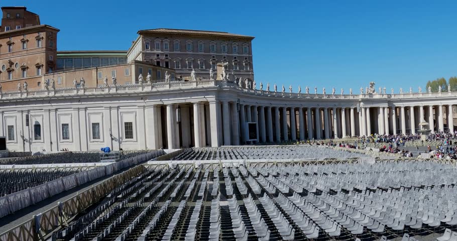Empty row of chairs in preparation of Eastern holiday ceremony at St. Peter Square. Group of tourists visiting the Vatican in on sunny summer day, aerial drone shot