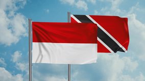 Trinidad and Tobago and Indonesia flag waving together in the wind on blue sky, cycle looped video, two country cooperation concept