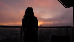 A silhouetted woman overlooking the city at golden hour - Powered by Shutterstock - Get 15% off with code: PIKWIZARD15