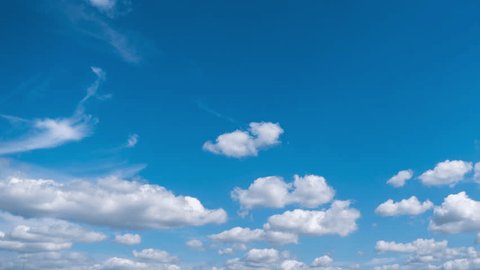 Timelapse of soft white cumulus clouds move in the blue sky. The background of light calm clouds changes shape in cloudy space. Natural background, time-lapse, copy space. 4K Adlı Stok Video
