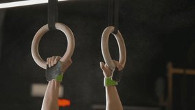 Close-up female hands with gymnastics grips grab a gymnastic ring. - Powered by Shutterstock - Get 15% off with code: PIKWIZARD15