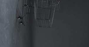 Vertical video of shopping trolley with copy space over grey background. Cyber monday, black friday, online shopping, shipping and global connections concept.