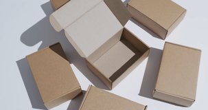 Video of cardboard boxes with copy space over white background. Cyber monday, black friday, online shopping, shipping and global connections concept.