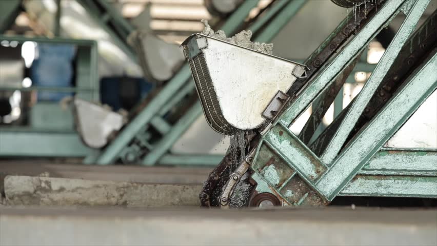 The close up view of the natural rubber sheet cleansing process by the auto industrial cleaning machines in a factory.