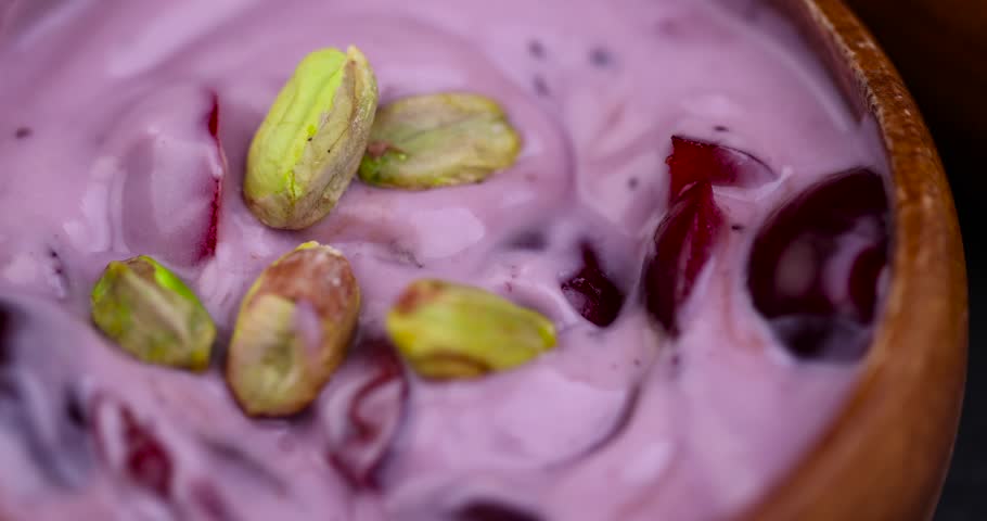 Fresh blueberry-flavored yogurt with ripe cherries and pistachios , natural purple yogurt with fresh cherries | Shutterstock HD Video #1108796277