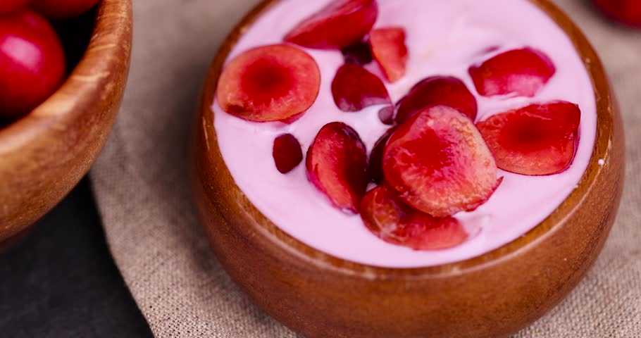 Cherry yogurt made of cream with the addition of pieces of sweet cherries, yogurt with taste and pieces of cherries | Shutterstock HD Video #1108796311
