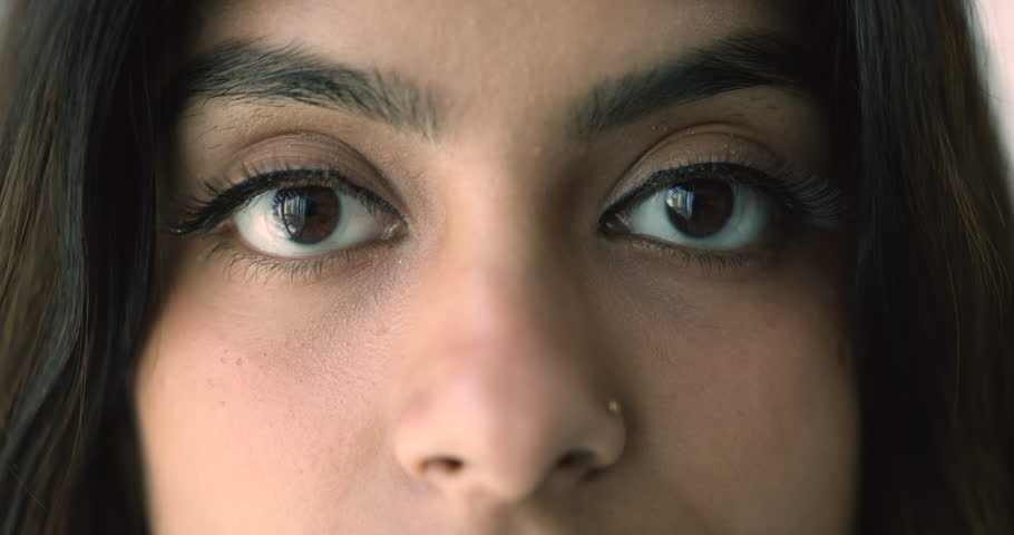 Close up cropped view happy Indian woman eyes staring at camera. Eyesight check up professional services ad, lenses shop advertisement, look at this world with wide open eyes with positivity and smile Royalty-Free Stock Footage #1108798203