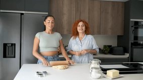 Mother and daughter explaining butter cookies recipe with sign language.