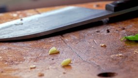 Big kitchen knife lying on an old dirty cutting board, after preparing food - Powered by Shutterstock - Get 15% off with code: PIKWIZARD15