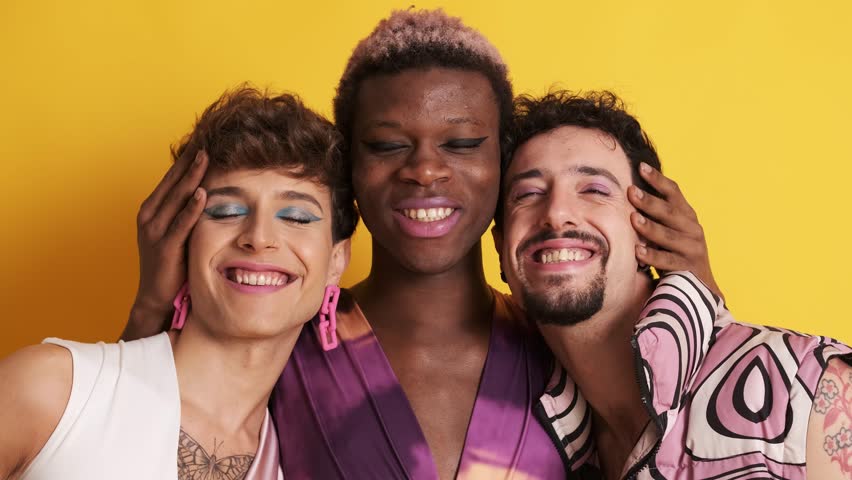 Multiracial transgender men smiling at the camera together