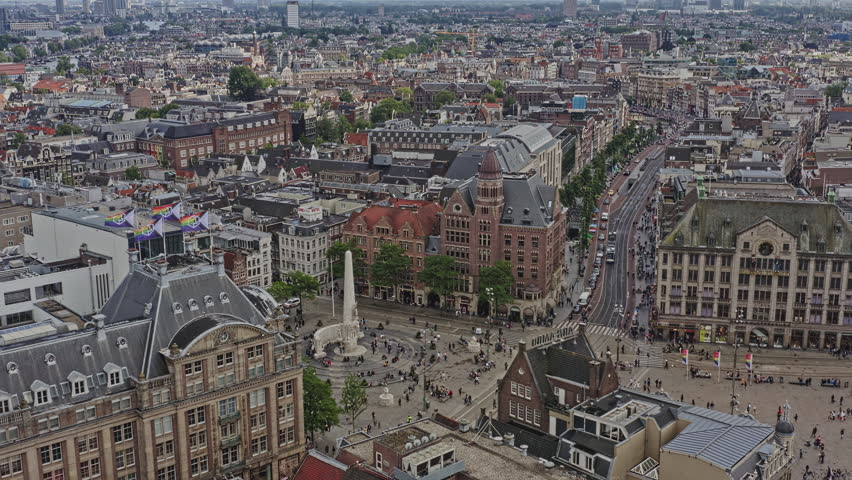 Amsterdam Netherlands Aerial v17 birds eye view overlooking at trams running across rokin street through dam square towards damrak street at binnenstad neighborhood - August 2021