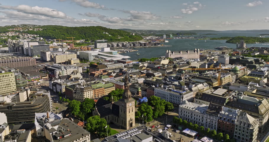 Oslo Norway Aerial v23 low level flyover Sentrum downtown area towards revitalized port Bjørvika waterfront neighborhood capturing iconic landmarks and attractions - Shot with Mavic 3 Cine - June 2022