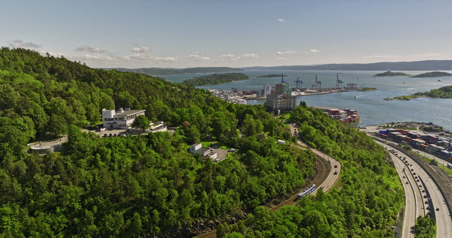 Oslo Norway Aerial v16 cinematic low level flyover Bekkelaget hillside neighborhood capturing waterfront shipyard and yachts and sailboats on the fjord in summer - Shot with Mavic 3 Cine - June 2022