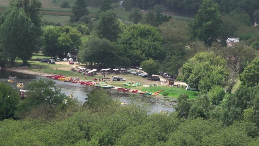 river bank full of tourists for recreation and activities