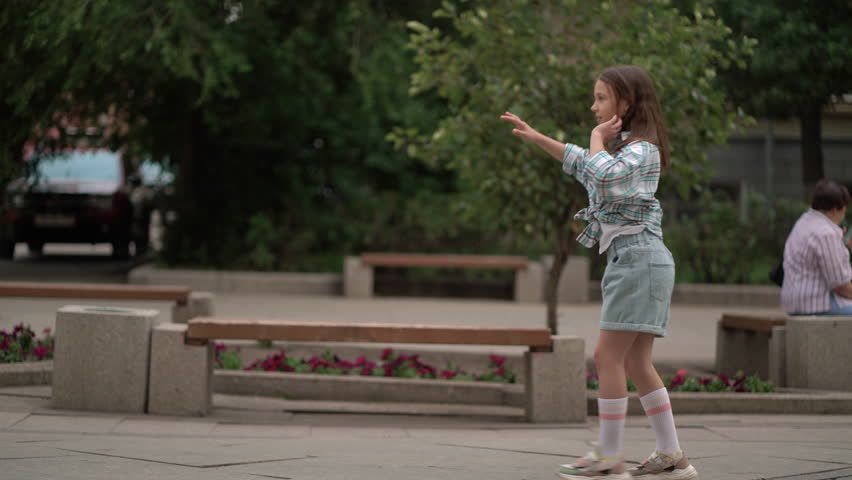 Child girl doing handspring on urban street