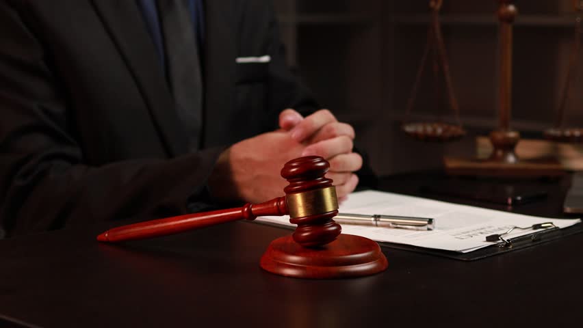 Lawyers read legal books defend their clients' cases, the lawyer concept assumes that the defendant defends the client in order to win the case or gain the greatest benefit in accordance with the law. Royalty-Free Stock Footage #1108818905
