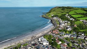 Aerial video of Ballygally Head Beach and Village on the County Antrim Coast road in Northern Ireland