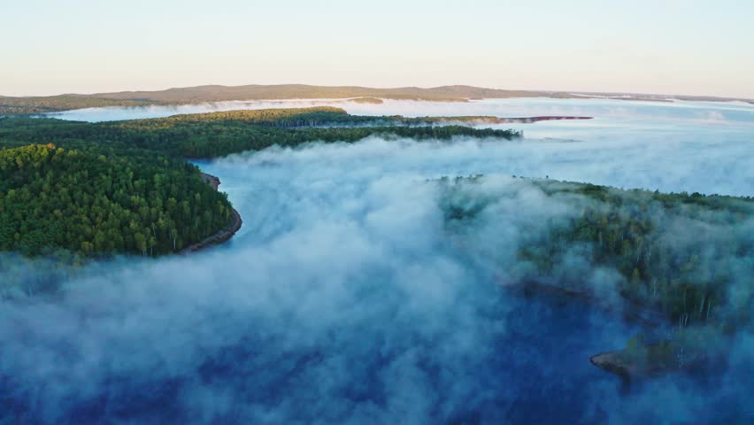 irds eye view of the morning lake in autumn, steam rises above the water, there is a green-yellow forest on the island. Drone video Royalty-Free Stock Footage #1108824359