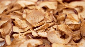 Sliced thin crispy apple chips falling in slow motion close up. Rotation - Powered by Shutterstock - Get 15% off with code: PIKWIZARD15