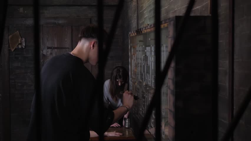 A young guy and a girl in a dark scary prison cell go through a quest, they solve logic puzzles. An interesting creepy quest for adults.