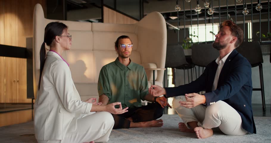 A girl in a white business suit, a guy in a green shirt and a man in a blue jacket are meditating during a break from work. Zen practice for harmony with yourself while working Royalty-Free Stock Footage #1108834481