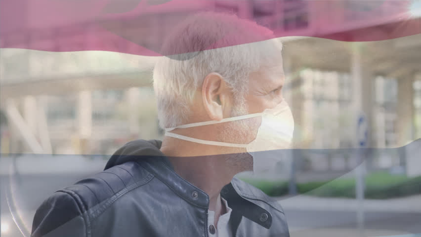 Animation of waving netherlands flag over portrait of caucasian man wearing face mask on the street. Global covid-19 pandemic concept - Powered by Shutterstock - Get 15% off with code: PIKWIZARD15