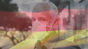 Animation of waving germany flag over portrait of caucasian man wearing face mask on the street. Global covid-19 pandemic concept - Powered by Shutterstock - Get 15% off with code: PIKWIZARD15