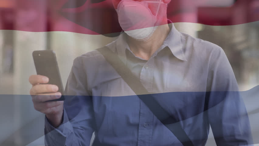 Animation of waving netherlands flag over caucasian man in face mask using smartphone on the street. Global covid-19 pandemic concept - Powered by Shutterstock - Get 15% off with code: PIKWIZARD15