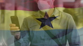 Animation of waving ghana flag against caucasian man in face mask using smartphone on the street. Global covid-19 pandemic concept - Powered by Shutterstock - Get 15% off with code: PIKWIZARD15