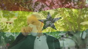 Animation of waving ghana flag against caucasian man wearing face mask coughing on the street. Global covid-19 pandemic concept - Powered by Shutterstock - Get 15% off with code: PIKWIZARD15