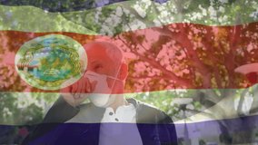 Animation of waving costa rica flag against caucasian man wearing face mask coughing on the street. Global covid-19 pandemic concept - Powered by Shutterstock - Get 15% off with code: PIKWIZARD15