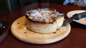 A video of Chicago-style pizza with delicious melted cheese.