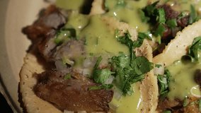 This close up video shows a panning of delicious classic pork tacos.