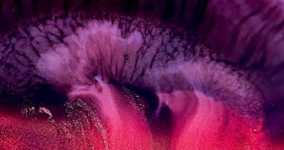 Amazing macro shot of purple red glitter particles slowly moving in liquid.
