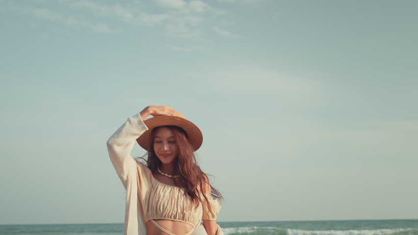Freedom happy Young Asian woman with straw hat walking on tropical beach, Carefree female enjoying breeze with sea in background. Travel vacation, summer outdoor pleasure. Royalty-Free Stock Footage #1108849133