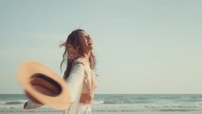 Freedom happy Young Asian woman with straw hat walking on tropical beach, Carefree female enjoying breeze with sea in background. Travel vacation, summer outdoor pleasure. - Powered by Shutterstock - Get 15% off with code: PIKWIZARD15